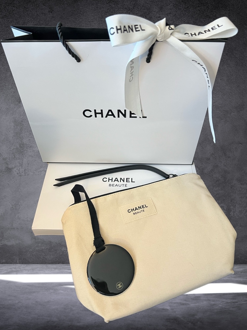 CHANEL Beige Canvas Pouch with Black Mirror Charm